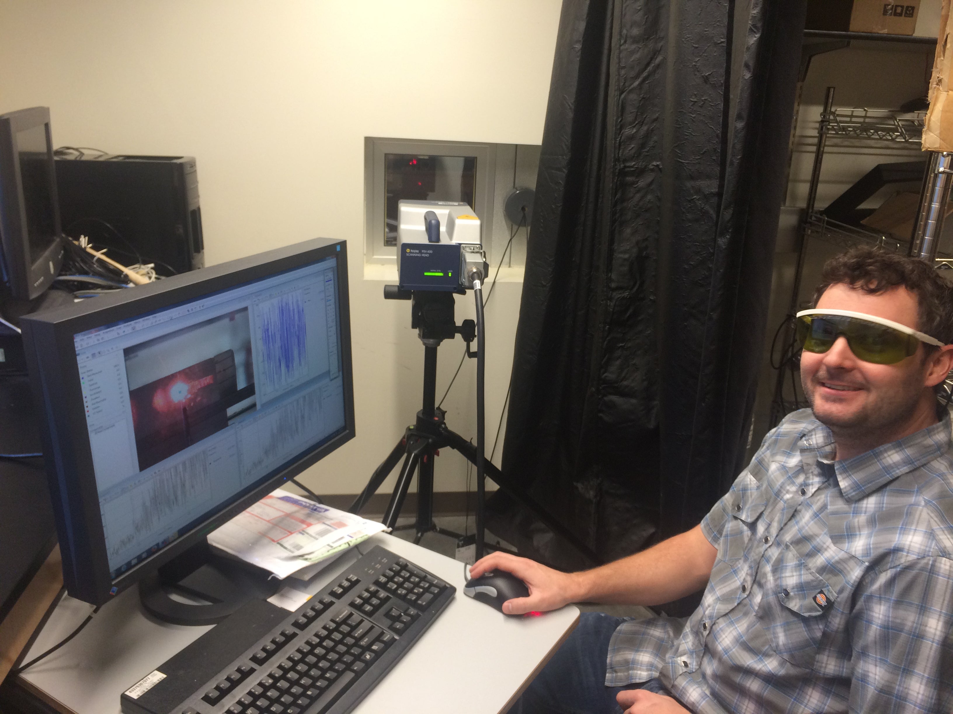 TomO making ultrasound measurements on an ice core (ice core is inside our cold lab beyond the laser window).