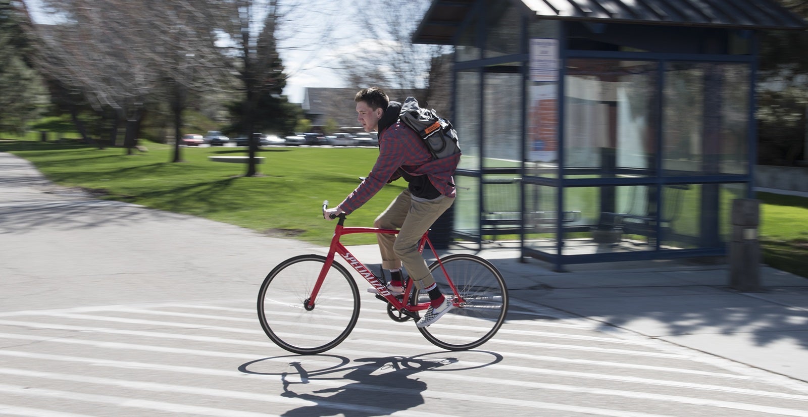 person riding bike through campus