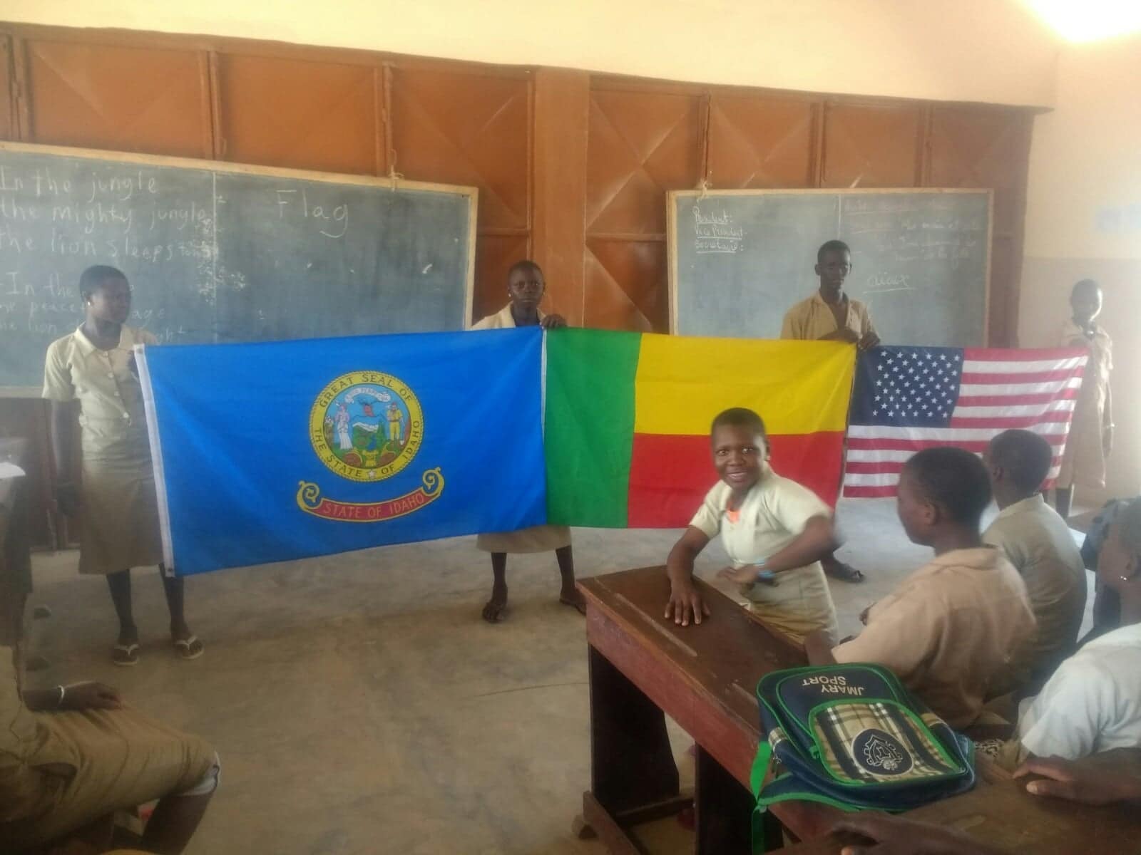 Students holding flags of Idaho, Benin, and the United States