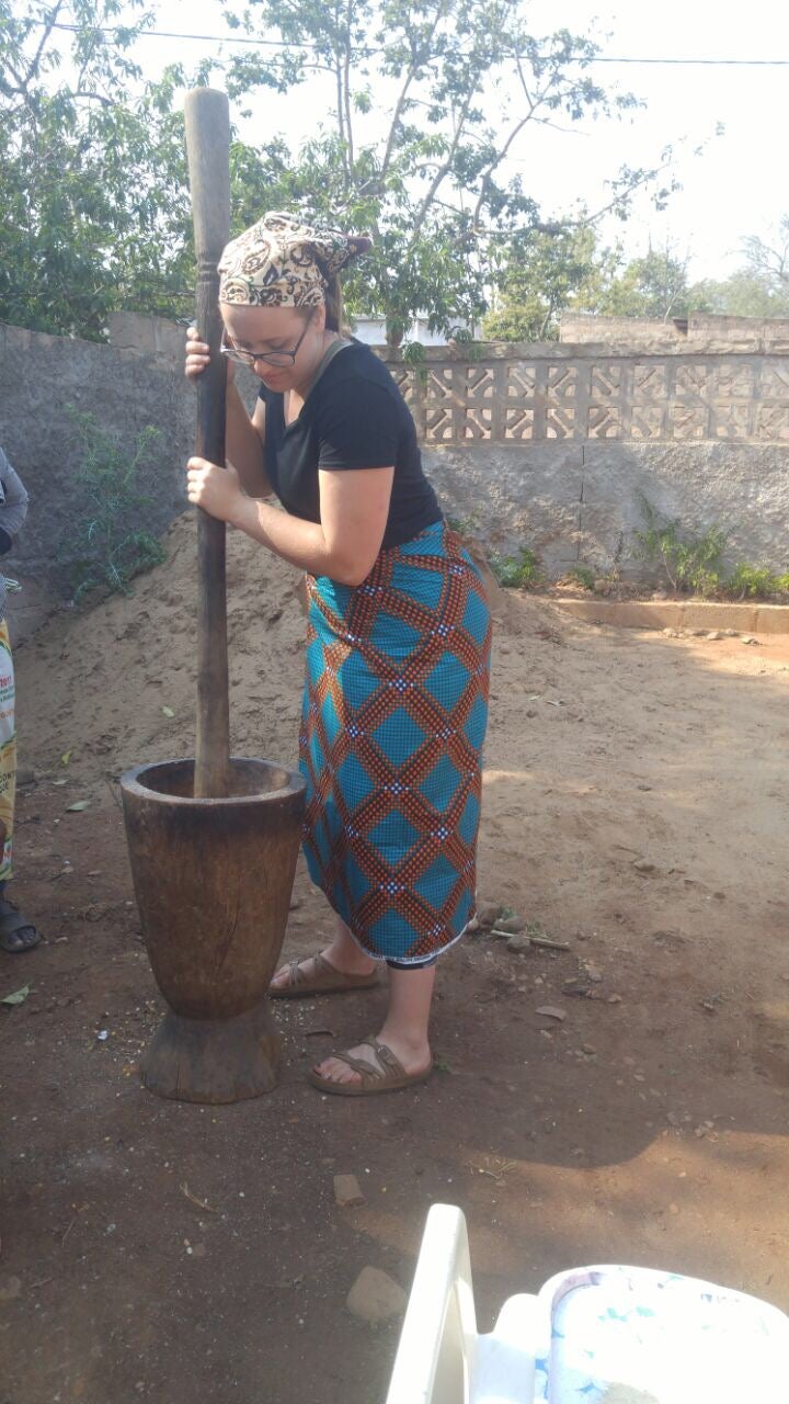 Jessica preparing food using traditional tools