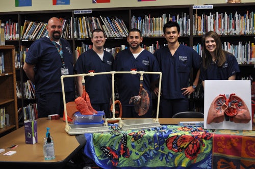 Radiologic Sciences students with pig lungs demonstrating effects of smoking