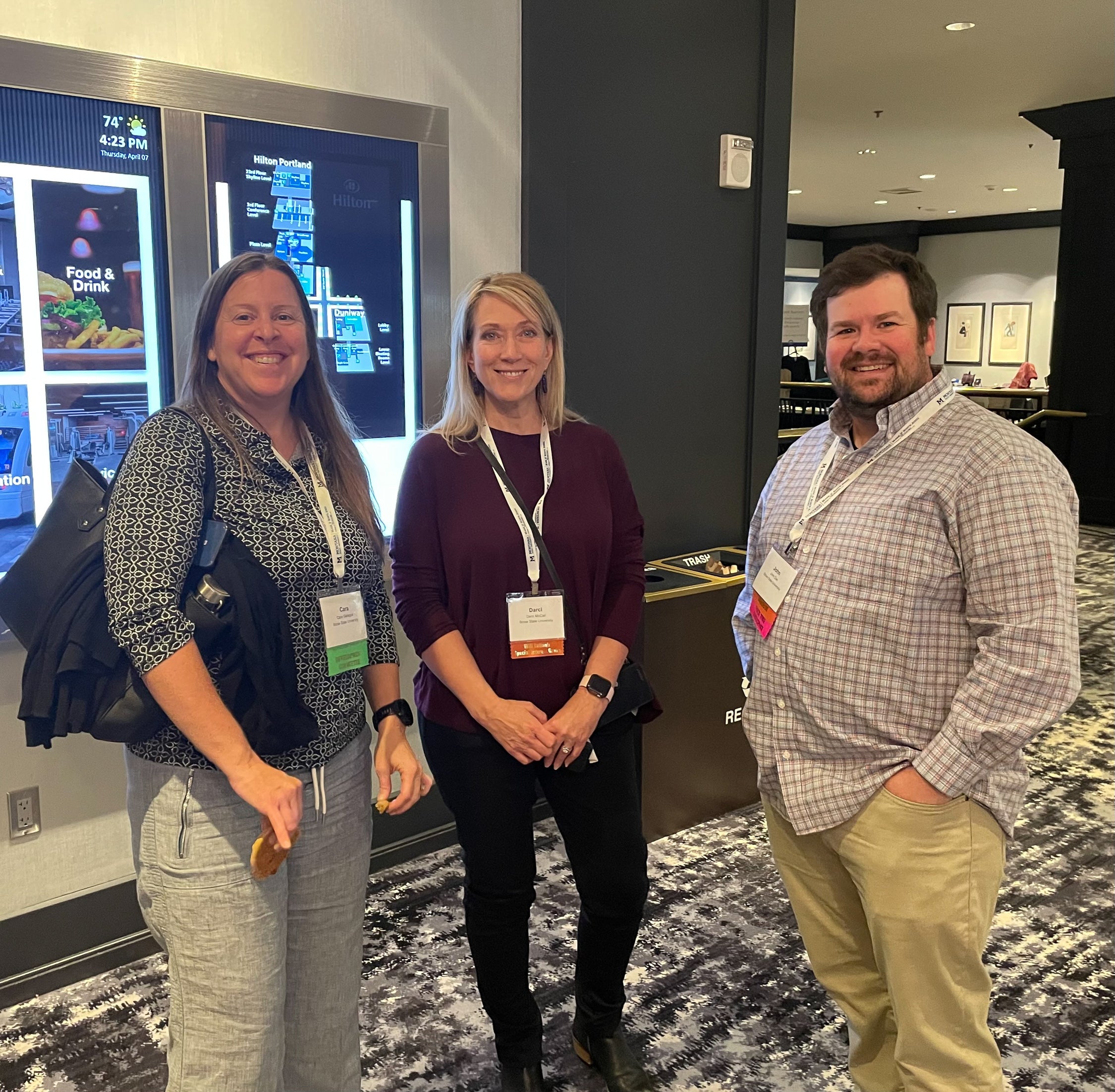 Associate professors Cara Gallegos and Darci McCall stand with nursing student John Dye at the 2022 Western Institute of Nursing conference.