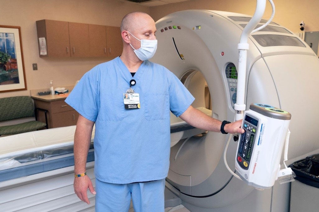 Boise State Imaging Sciences alumni Ryan Harper, 2021 graduate, setting up a CT scanner