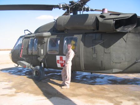 Jenny Alderden stands in front of a medical transport helicopter.