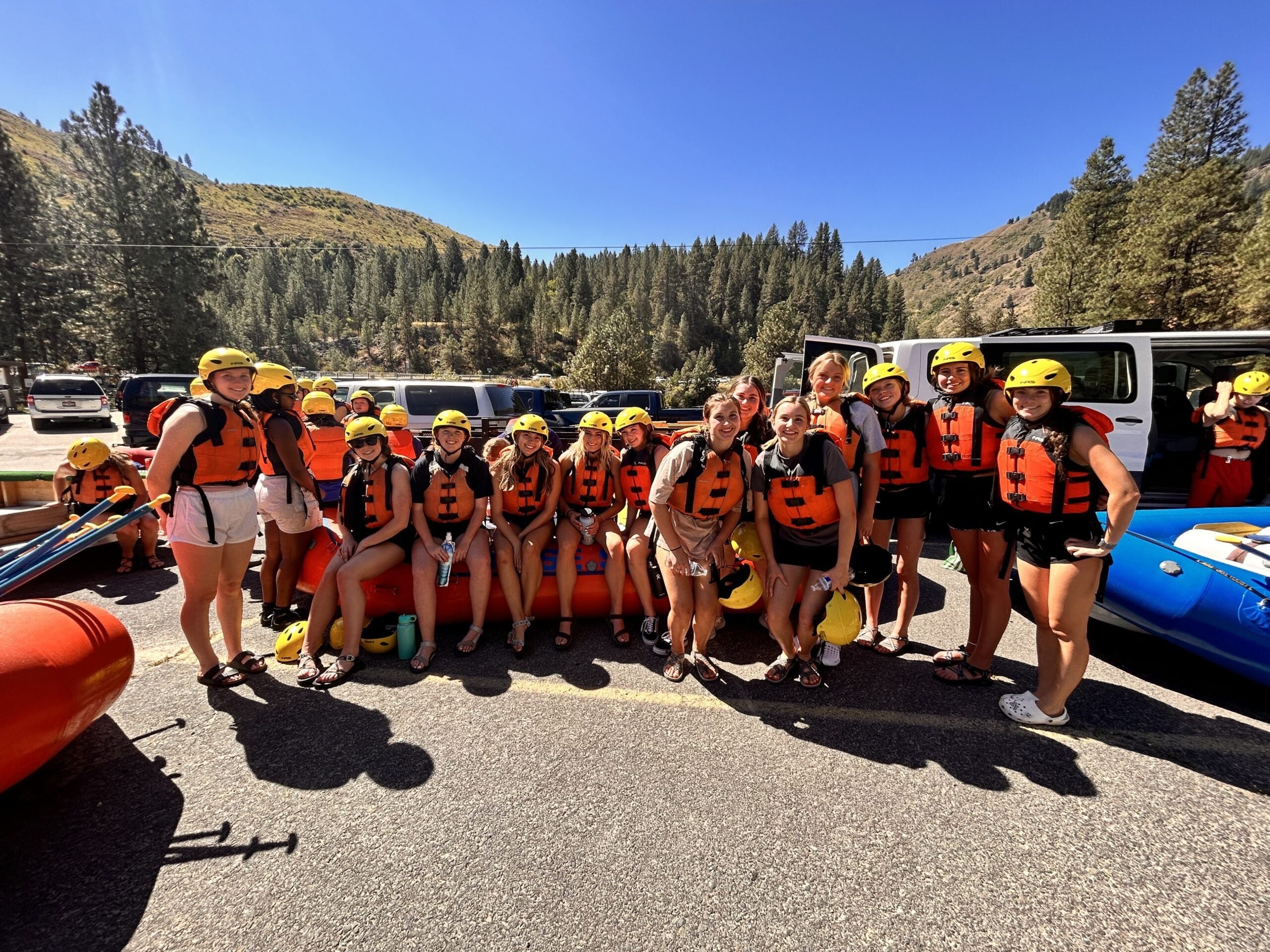 BroncoFit Living Learning Community pose in lifevests and helmets before a river rafting excursion.