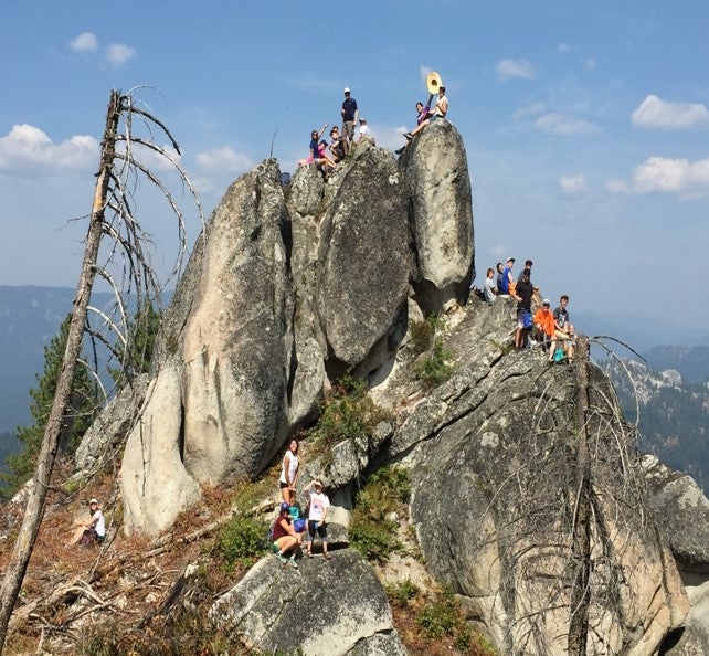 students pose on a rocky hillside