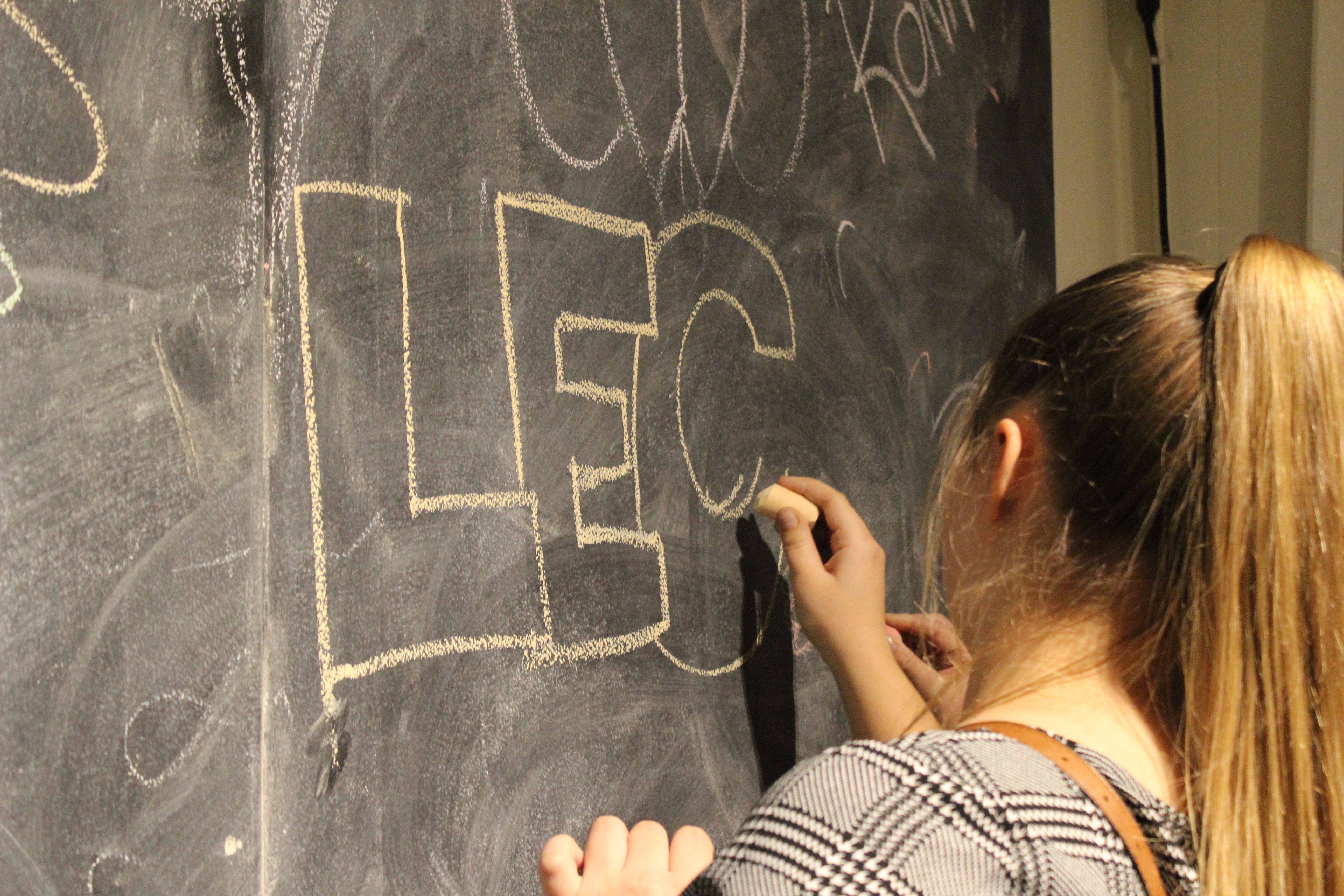 Student writing on a chalkboard