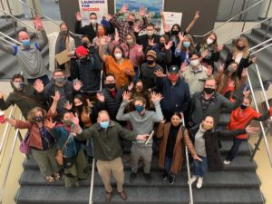 2021 shared leadership group photo, all participants are wearing masks and waving their hands in the air