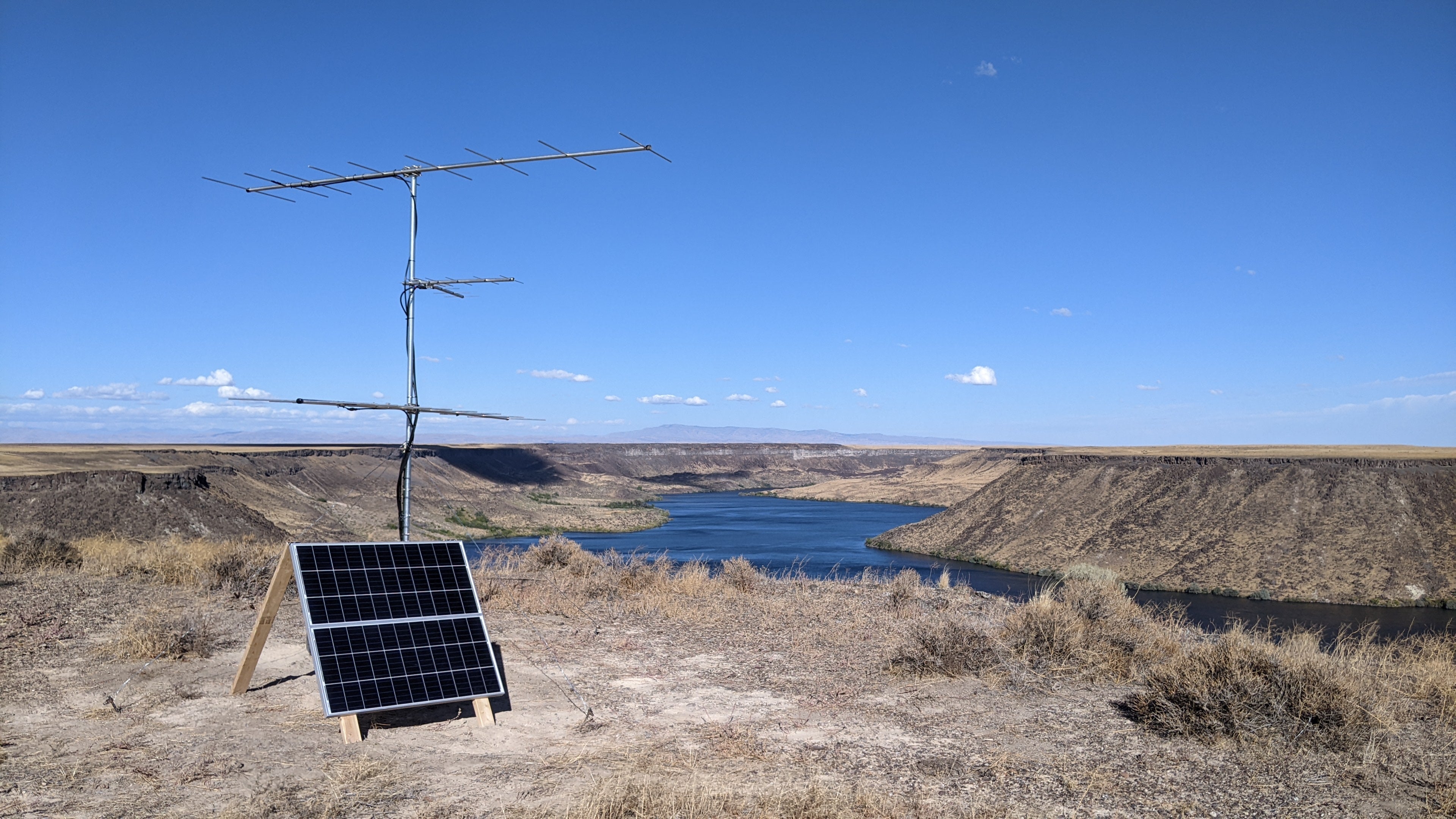 a solar panel and large antenna stand in the foreground. Behind you can see CJ Strike reservoir