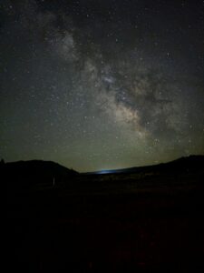 An Image from the Idaho Dark Sky Reserve in Stanley, Idaho. The milky way is visible in the sky but light pollution coming from Boise creates a blue haze blocking out stars close to it. 