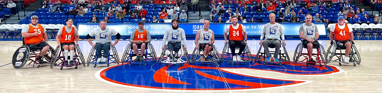 Boise State Adaptive Athletics Basketball team  line their wheelchairs up for portrait on the court