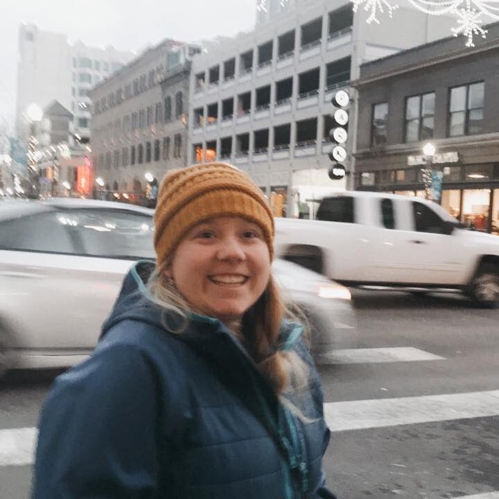 Young woman standing at a busy street corner