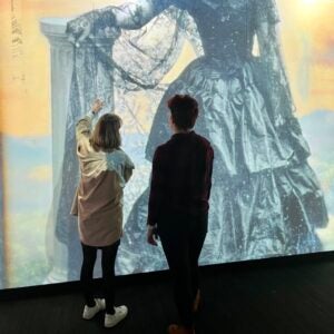 Two students look at an enlarged photograph in the Luminary