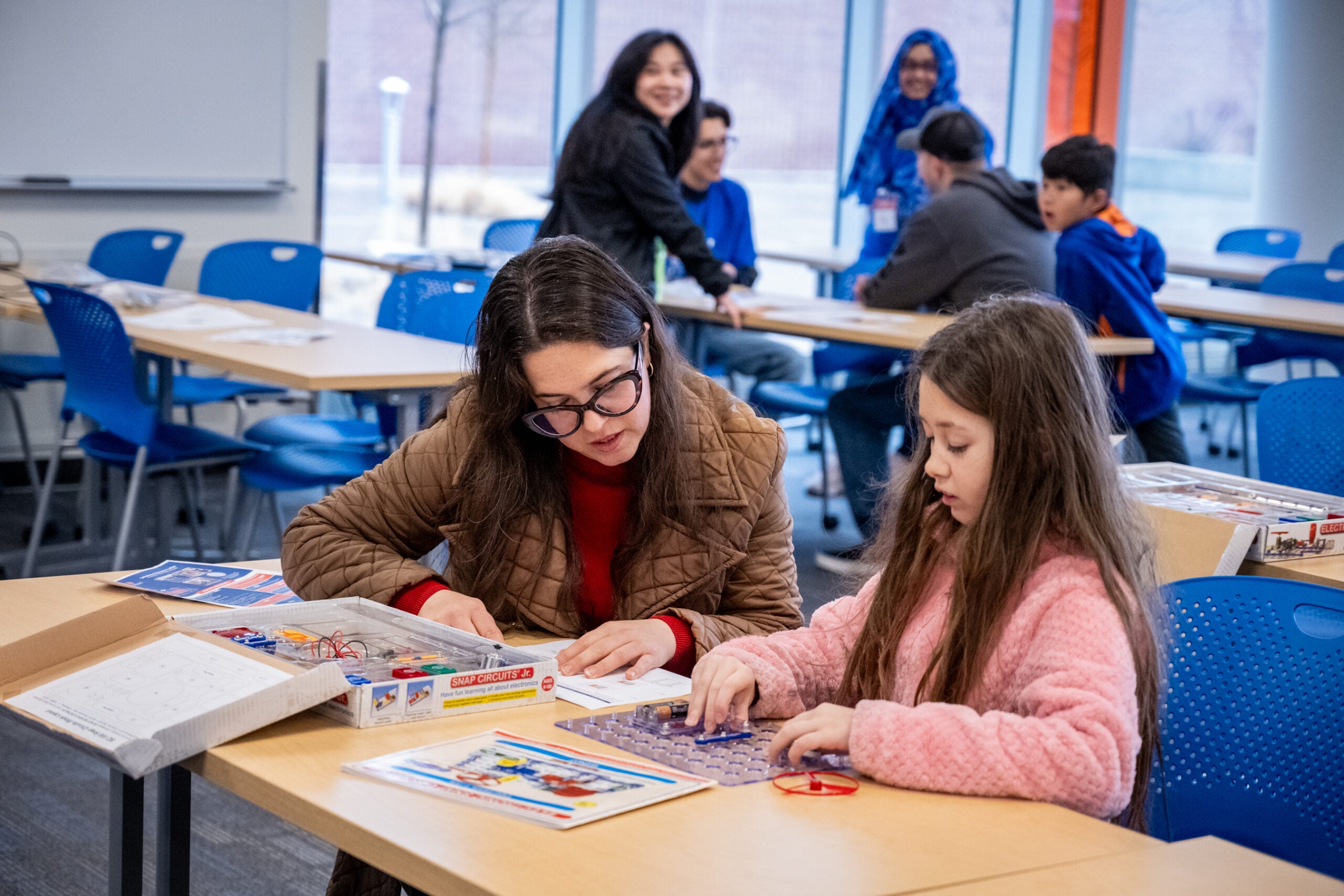 adult and child using a learning circuit board