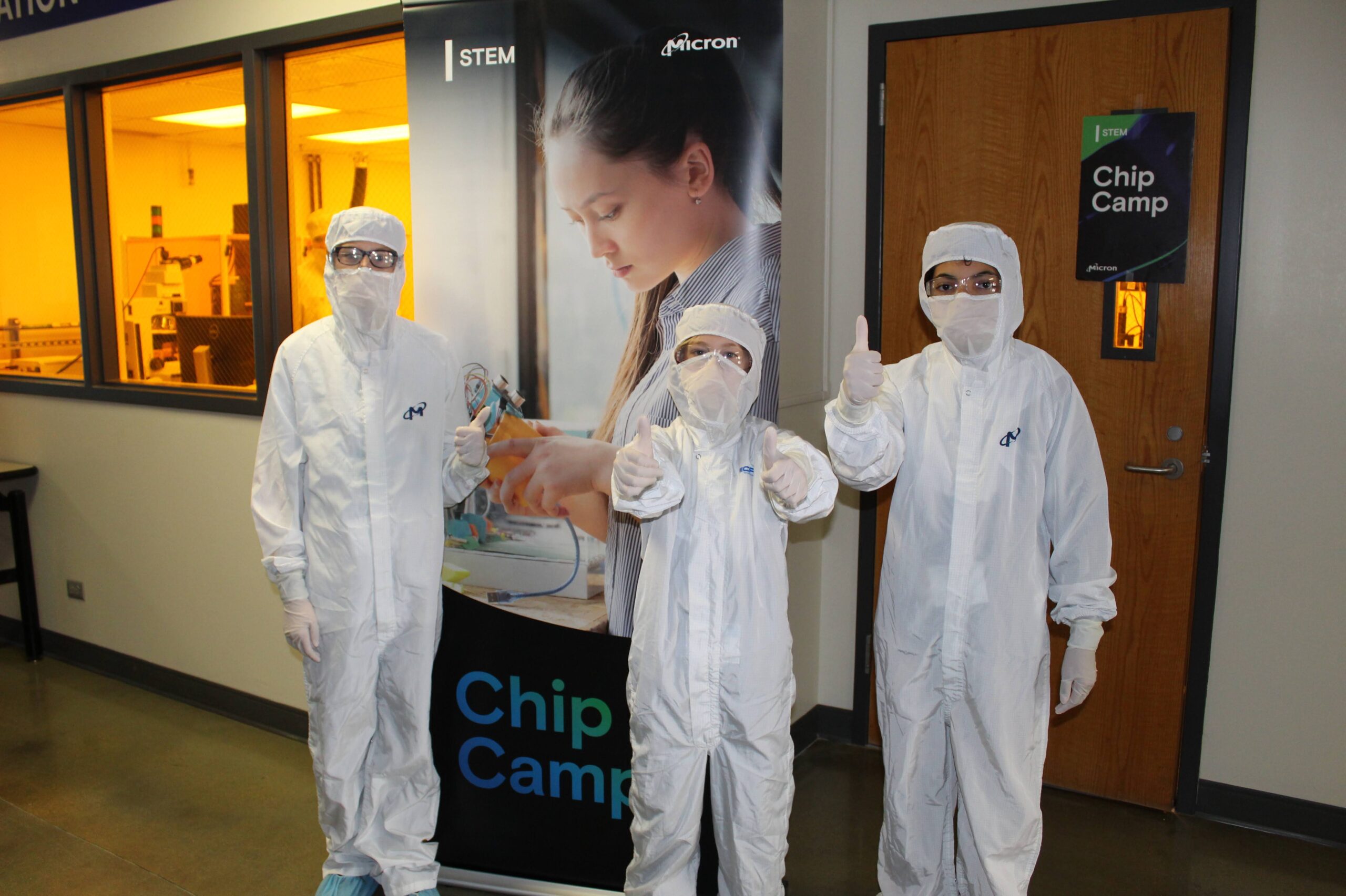 k-12 chip camp attendees in lab coveralls