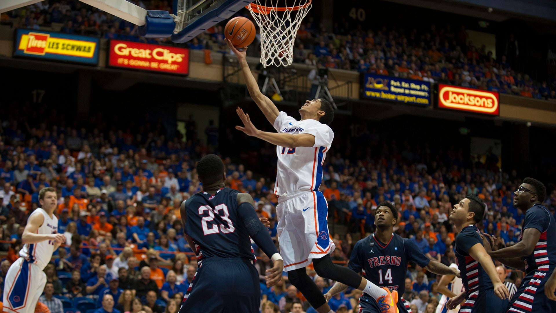 Boise State Basketball player jumps to put ball in hoop