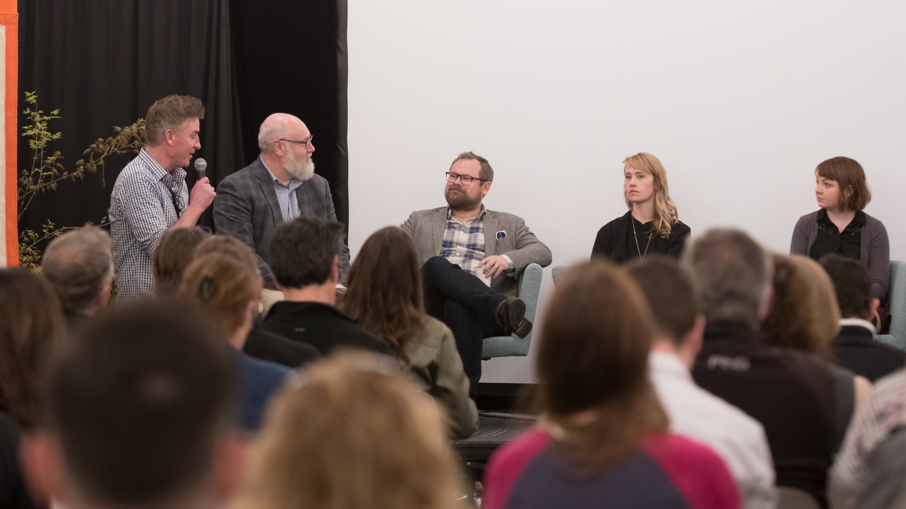 Audience member asks question of panel