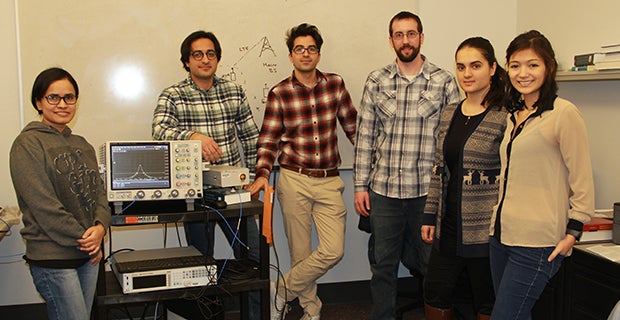 A graduate research group poses in the lab.