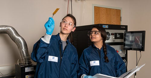 Two students examine graphene