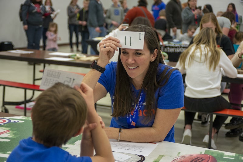 A Boise State student works with a middle schooler