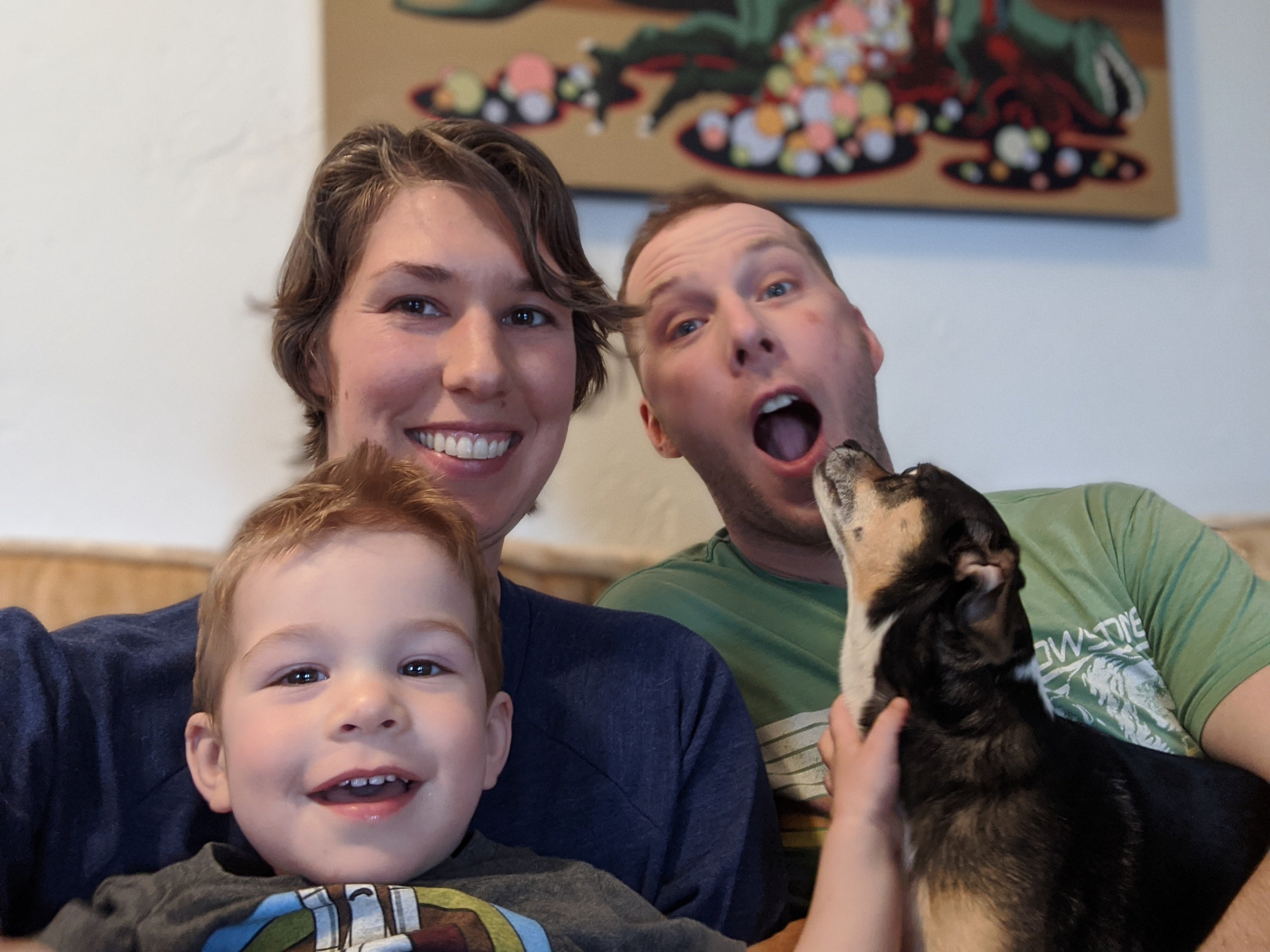 Photo family of three slightly interrupted by dog
