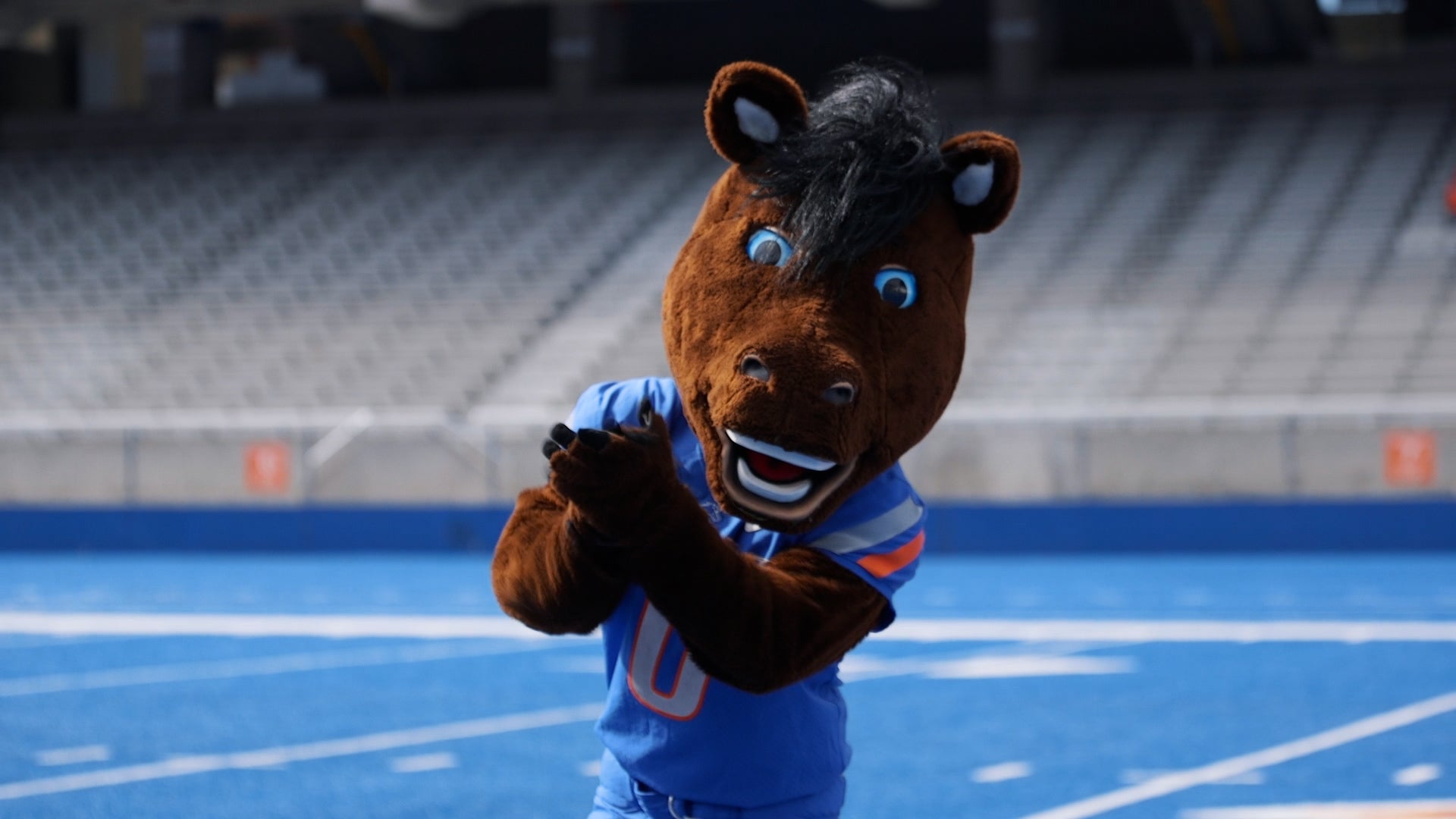 Mascot Buster Bronco on the blue turf