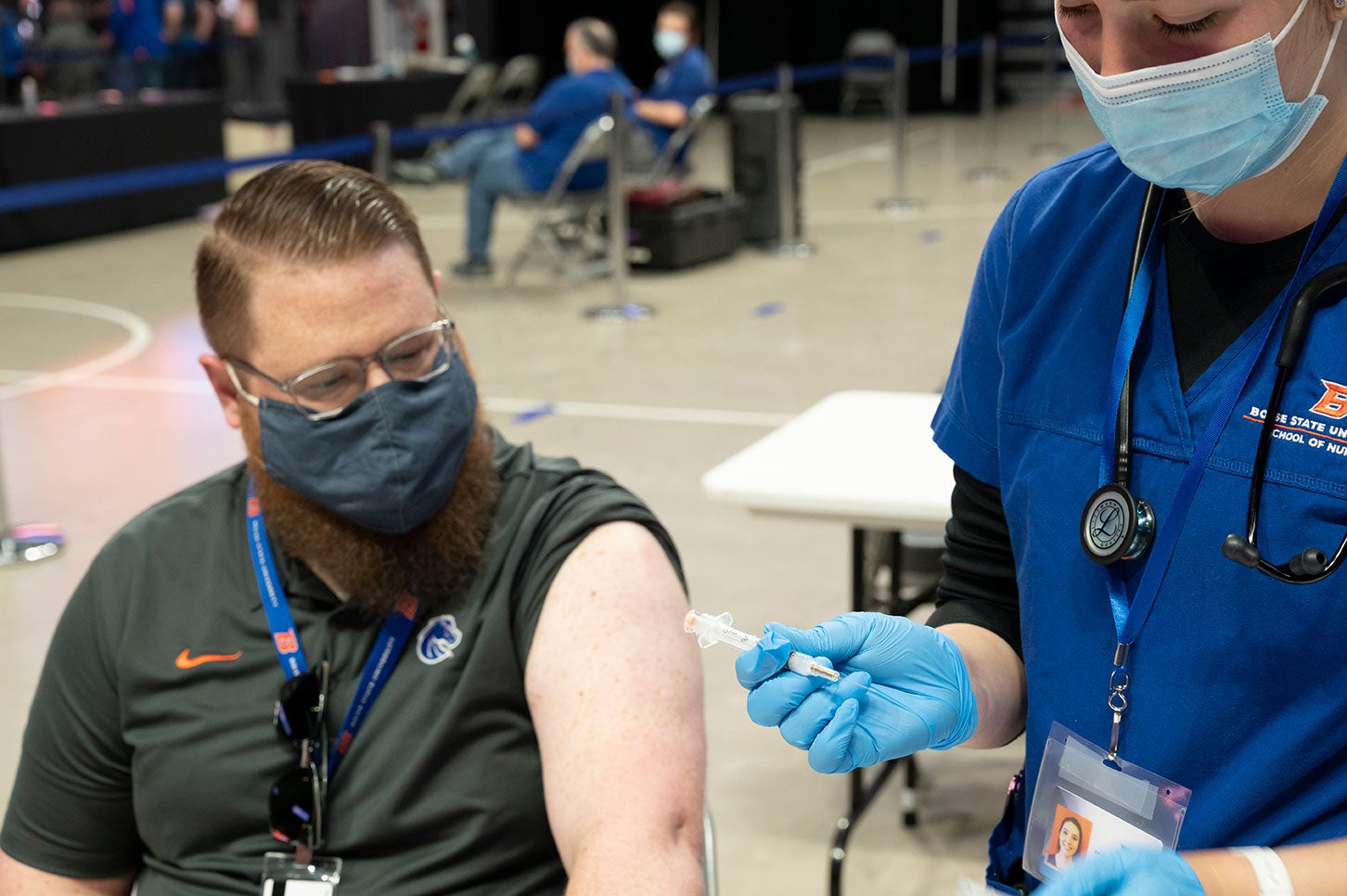 Nursing student prepares to give a vaccine at Boise State COVID mass vaccination clinic, Extra Mile Arena, April 3, 2021