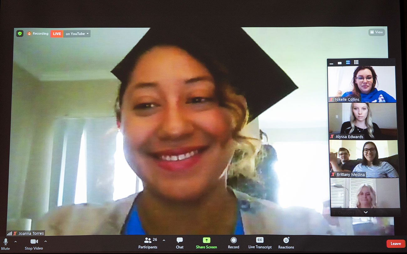 August 2021 MSW graduate Joanna Torres joins the hooding ceremony over Zoom.