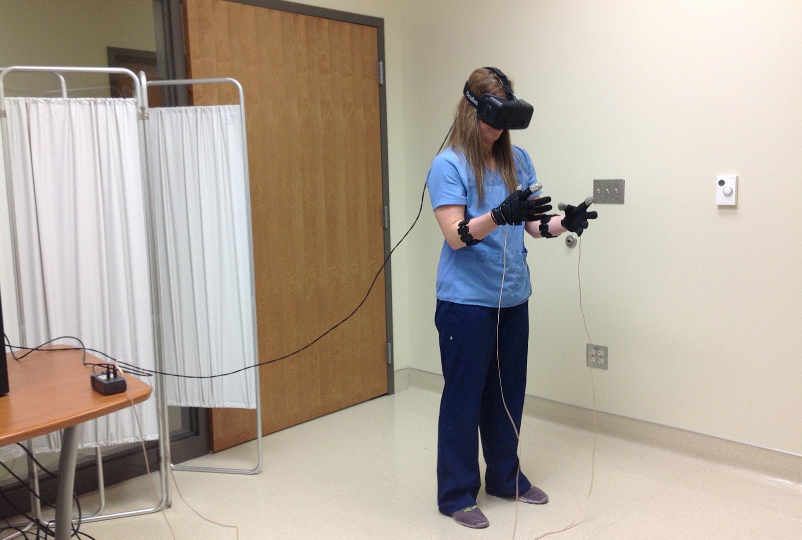 A nursing student practices with a virtual reality system.
