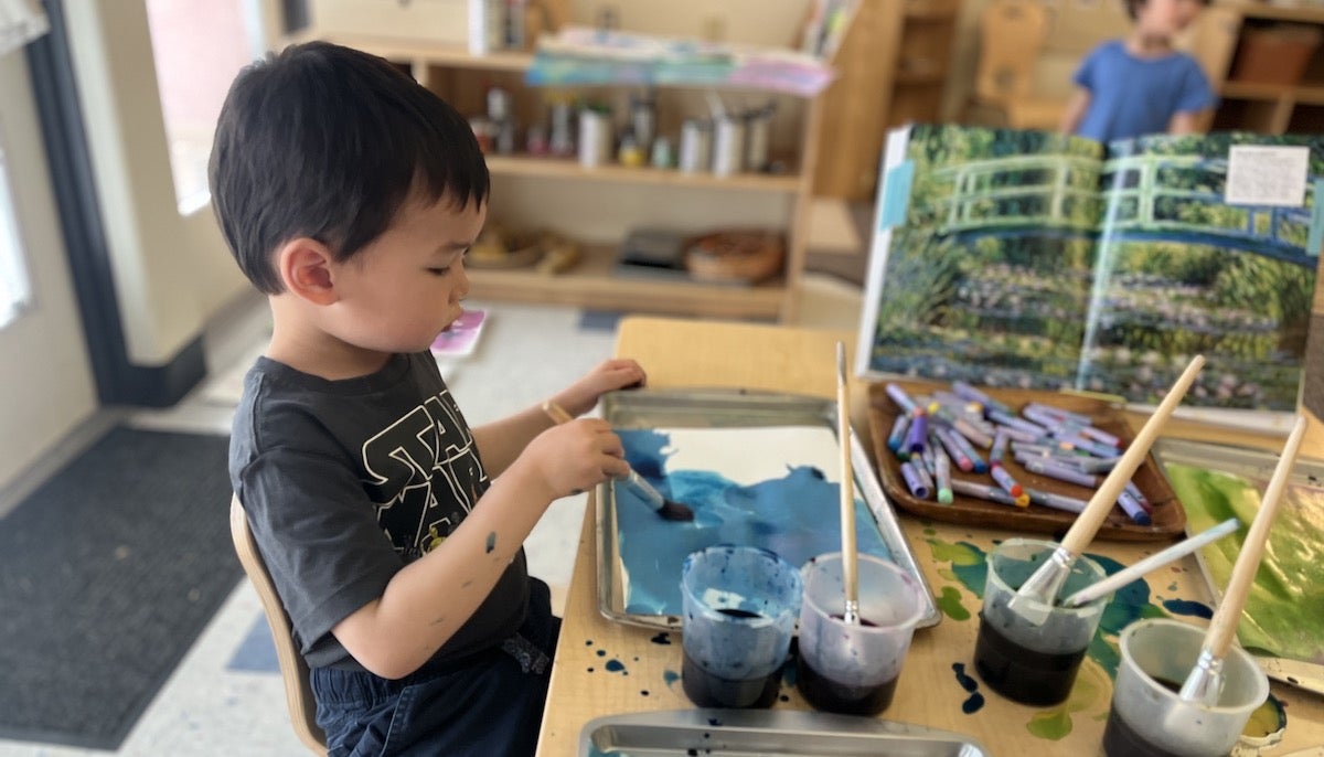 A child does an art project in a preschool classroom