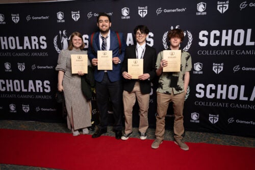 Four Boise State Esports players holding their scholars awards.