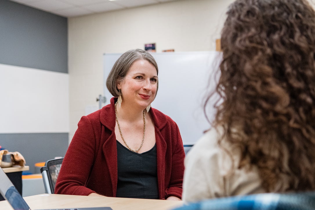 Jenn Mallette, professor of English, with a student in the classroom.