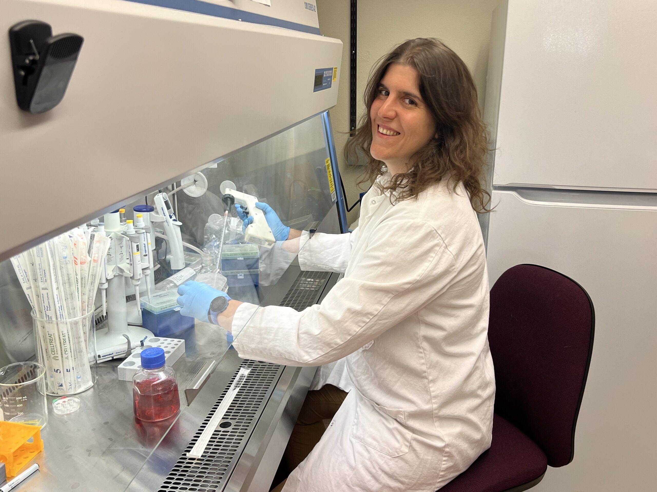 Assistant Professor Sophia Theodossiou working in lab