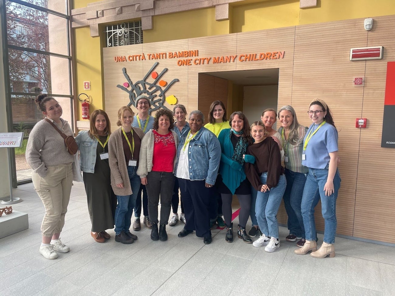 A group poses in front of a preschool