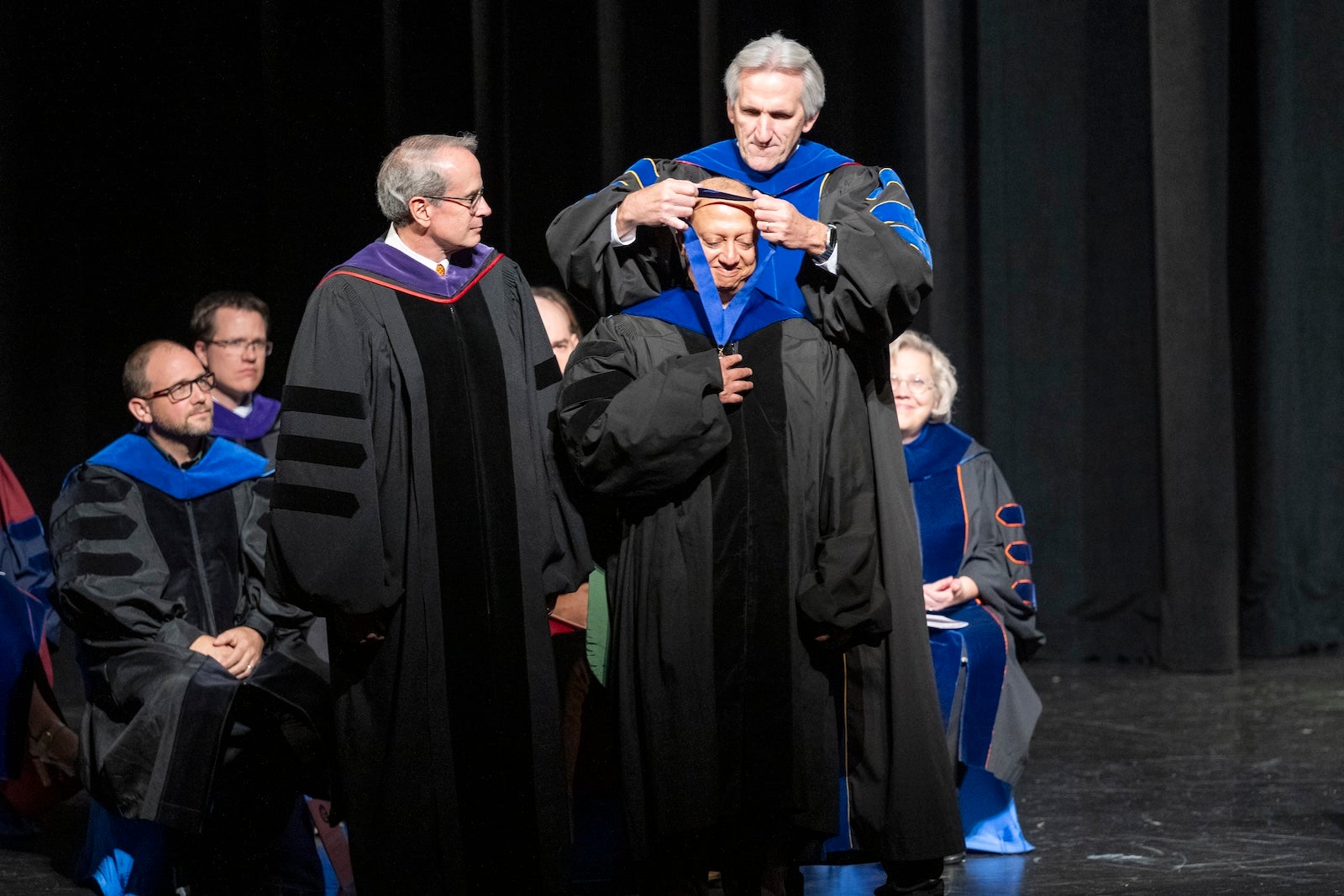 A person in regalia receives a medal