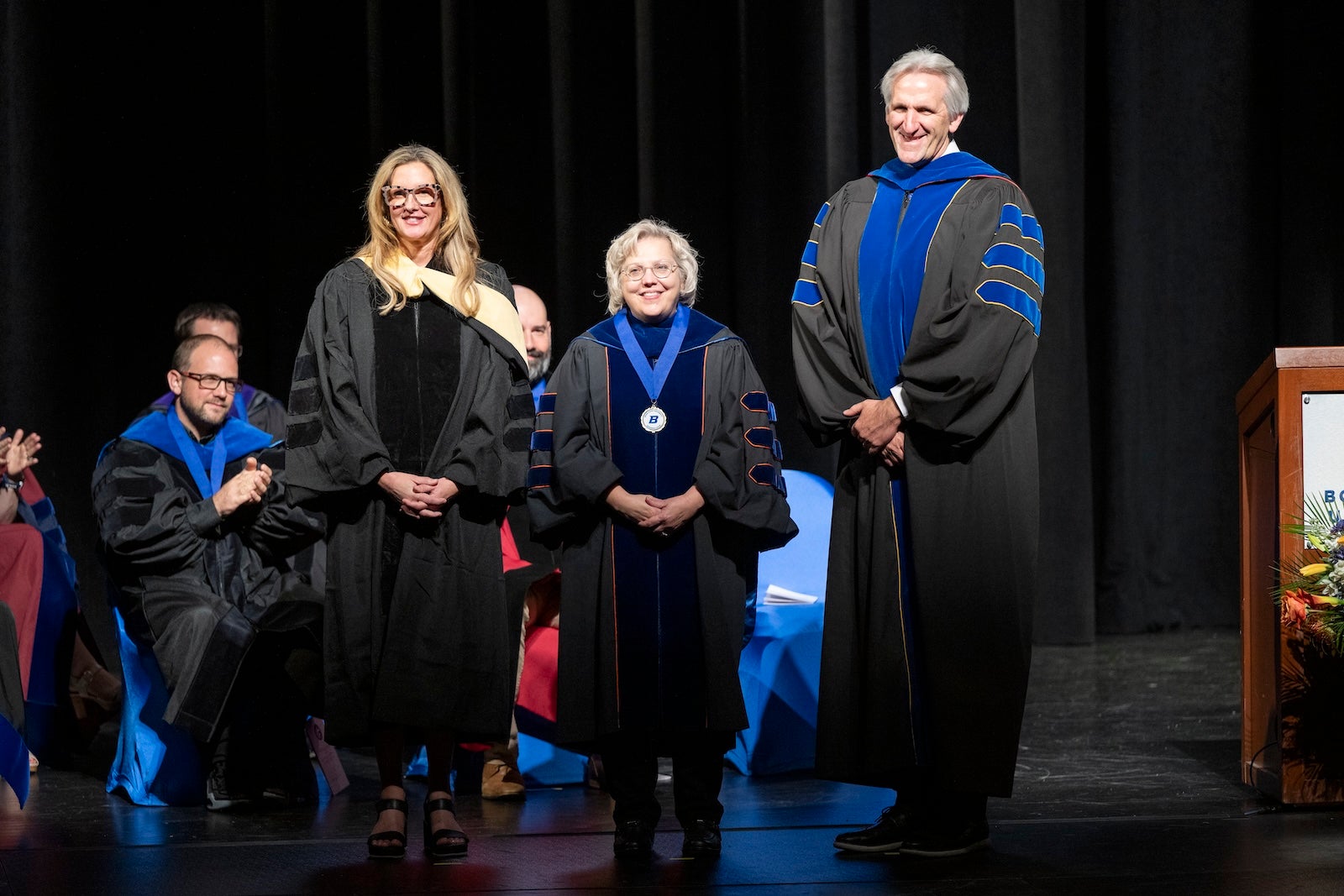 Persons in regalia pose for photo