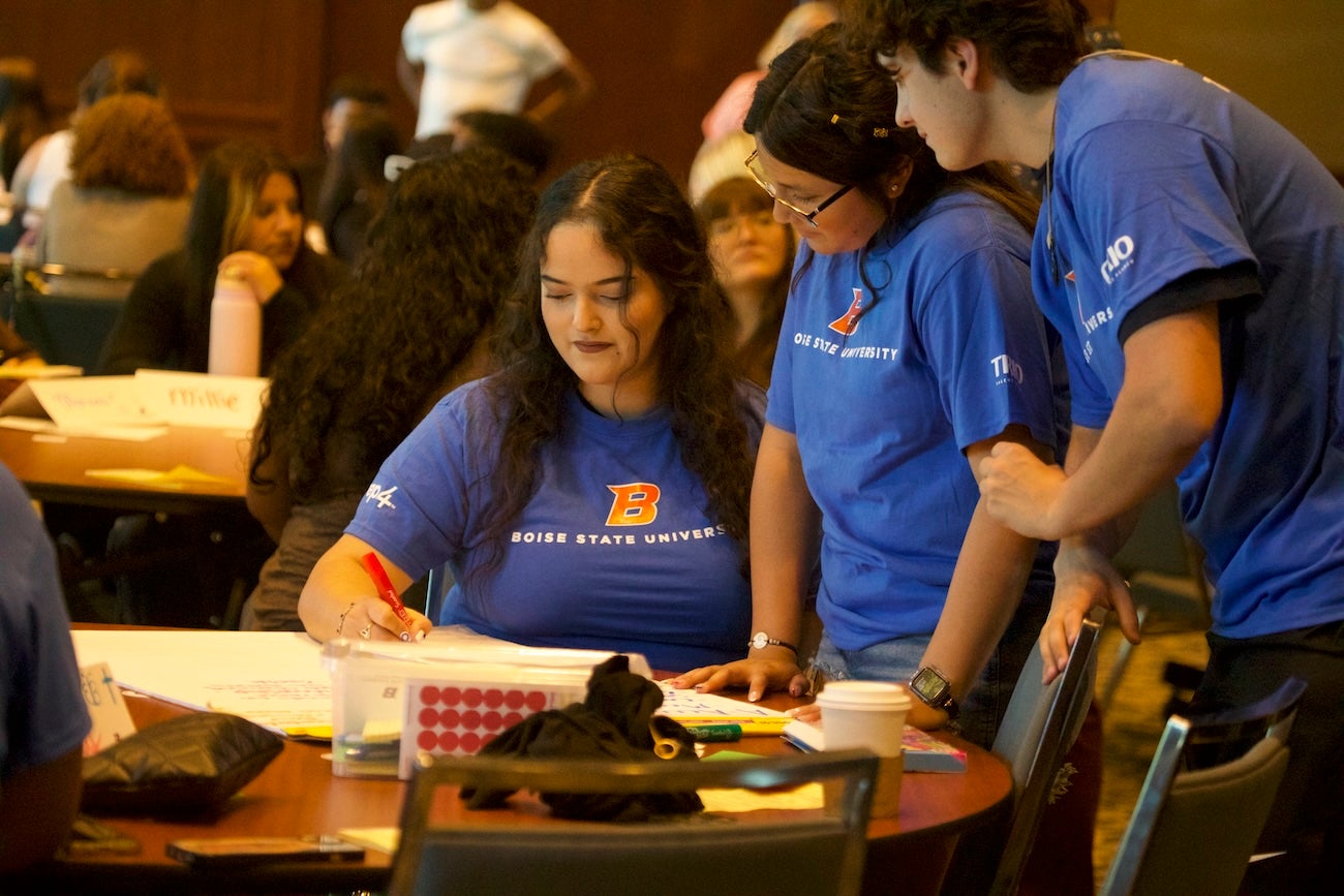 Students collaborate at a table