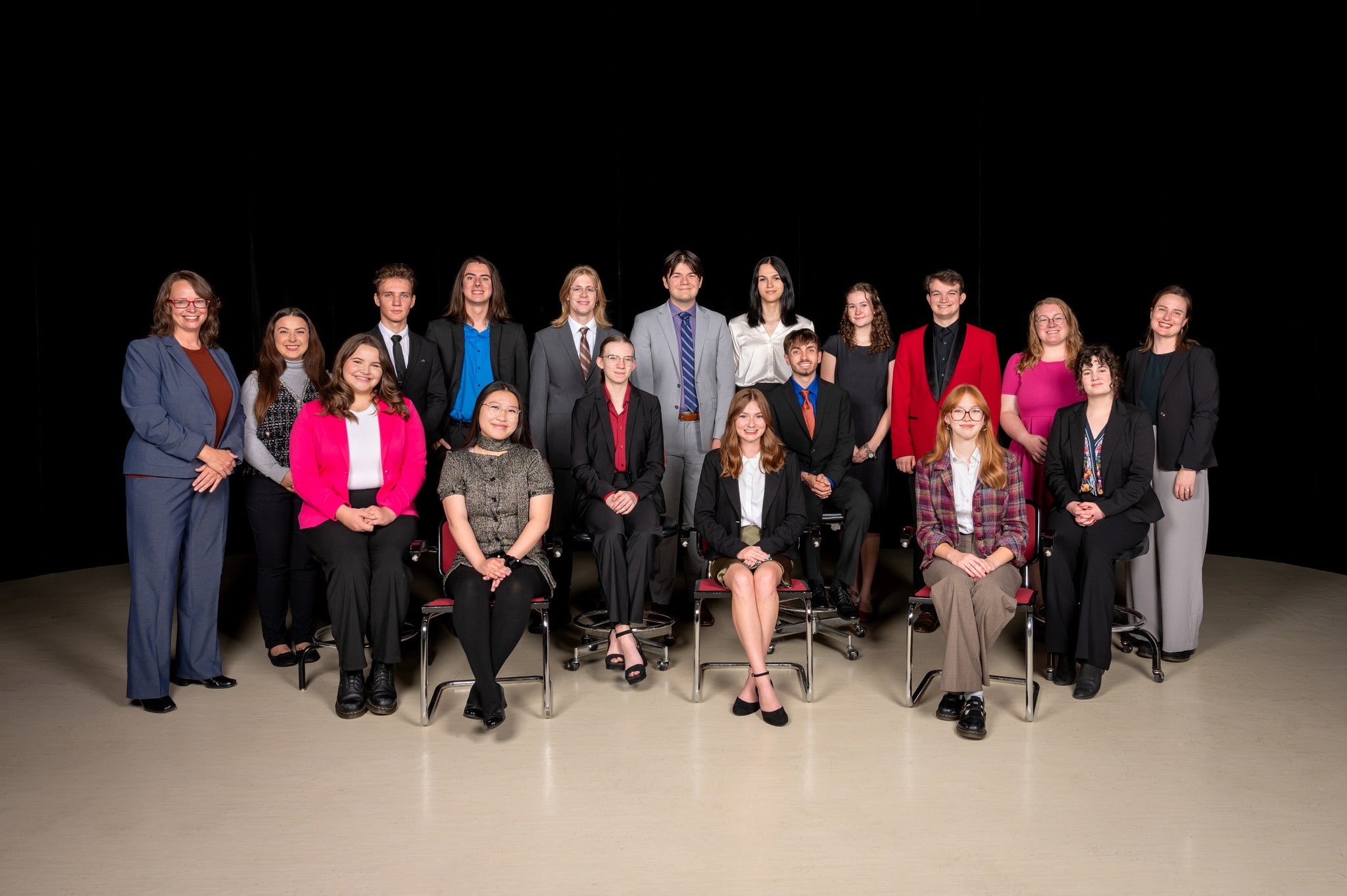 Persons pose on a stage 