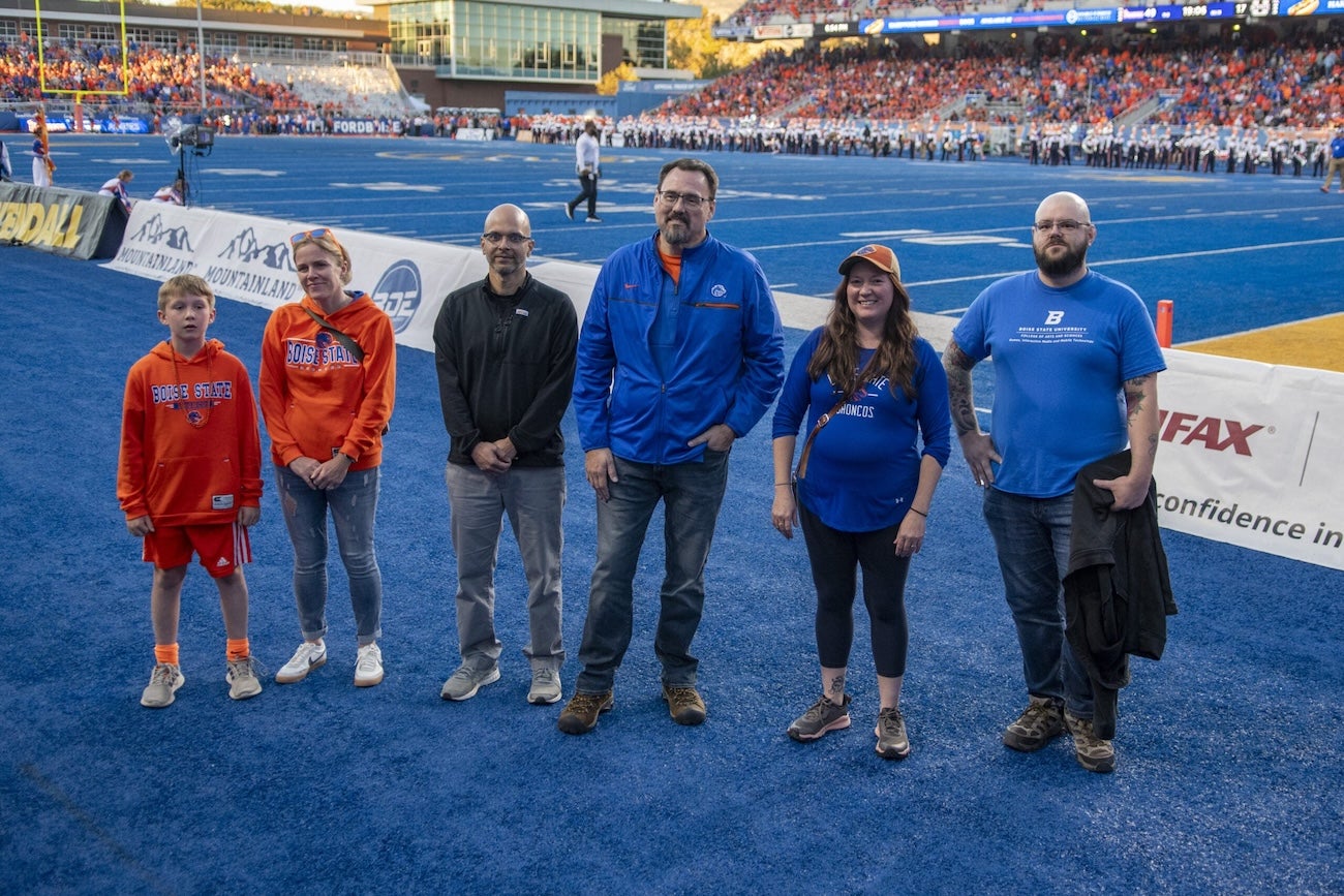 Faculty from the College of Arts and Sciences pose for a photo on The Blue