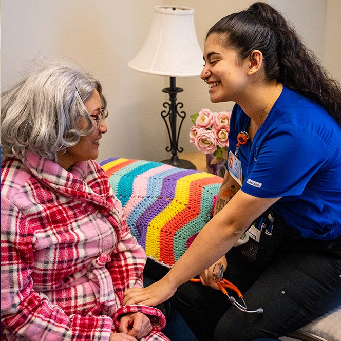 A nursing student interacts with an actor performing an patient simulation 