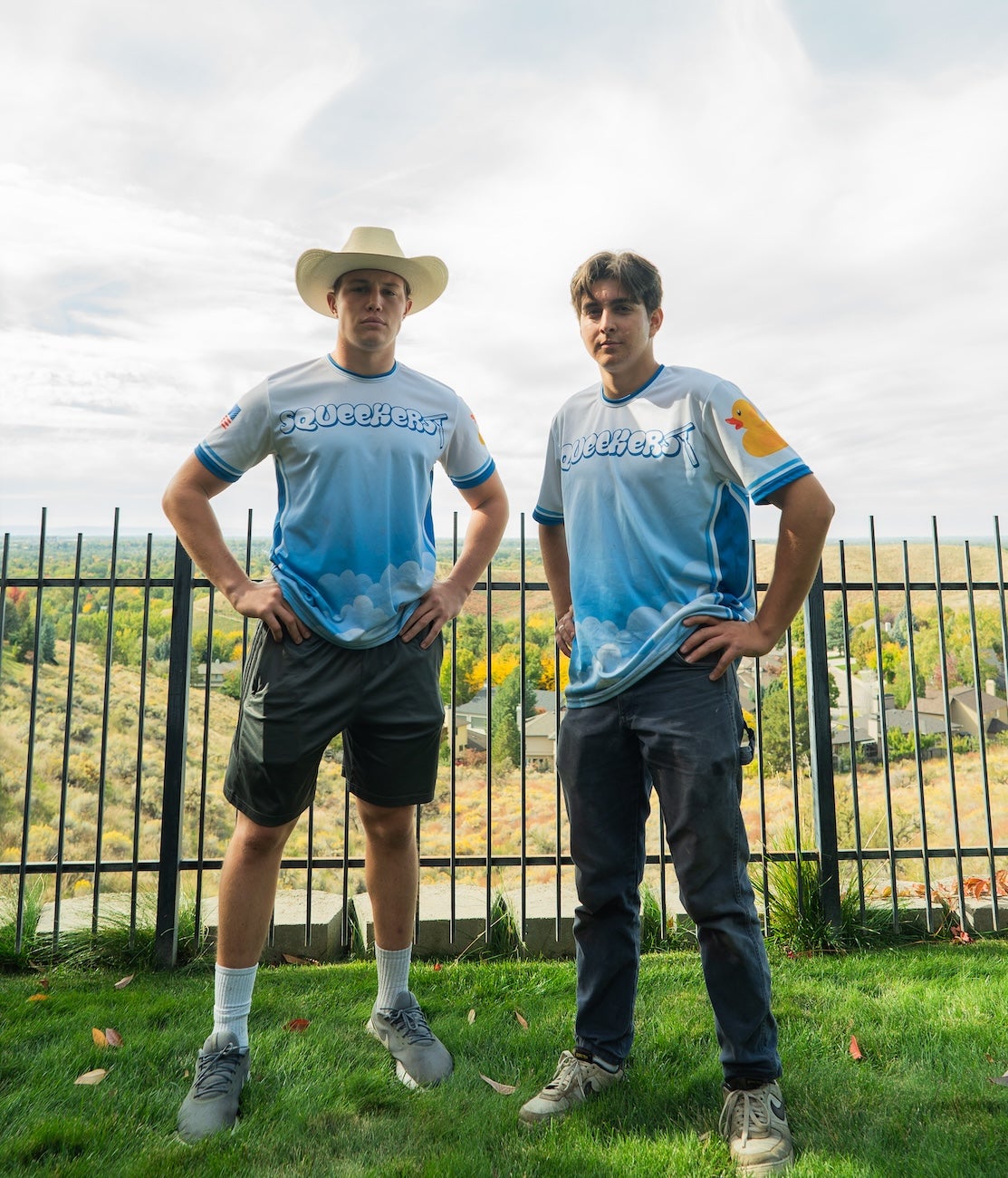 Two persons pose in their company uniforms