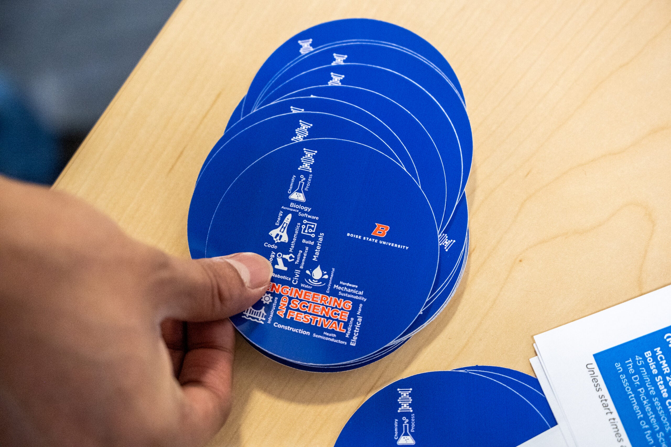 A student grabs a Engineering and Science Festival sticker at the 17th Annual event.