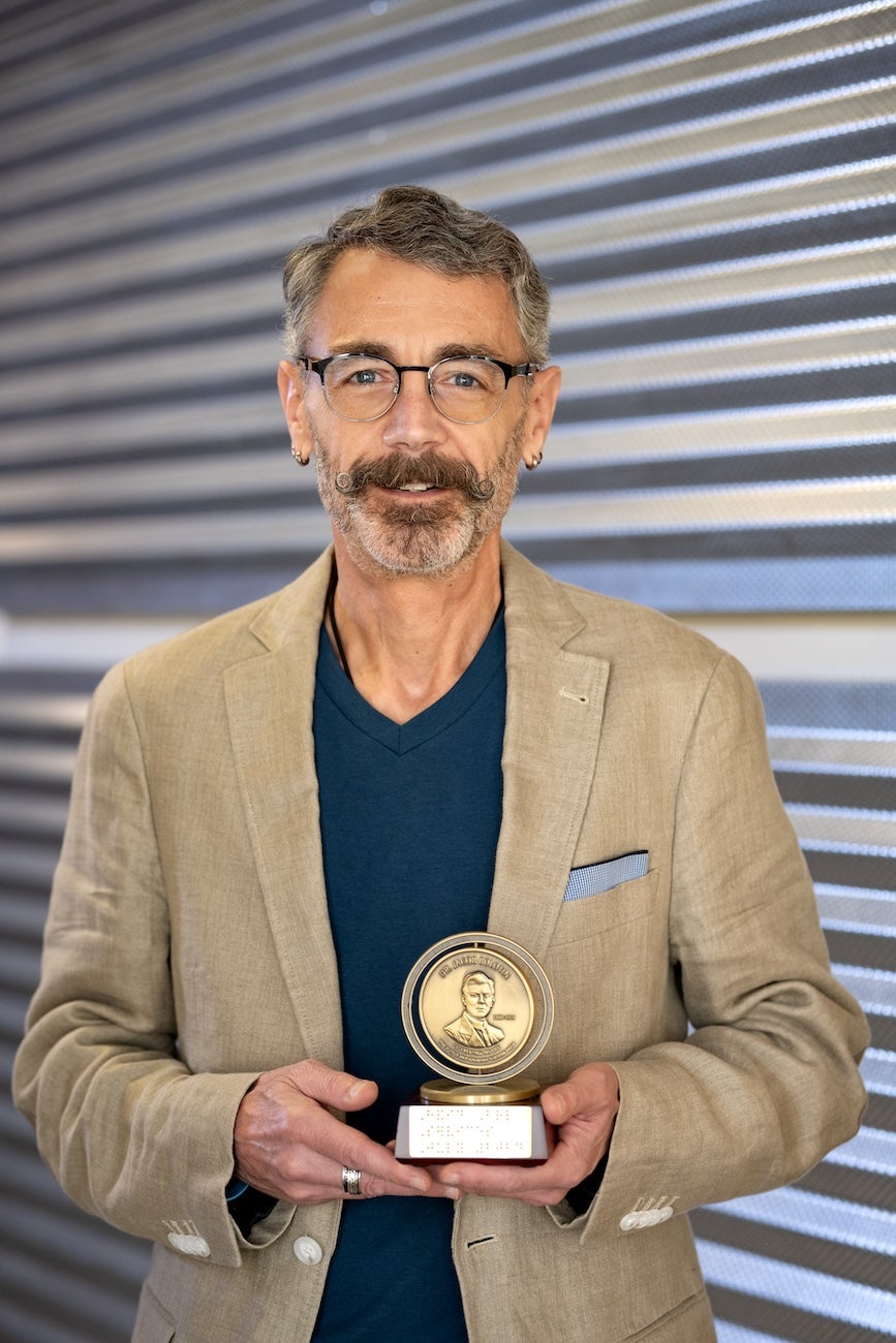 A person holds an award