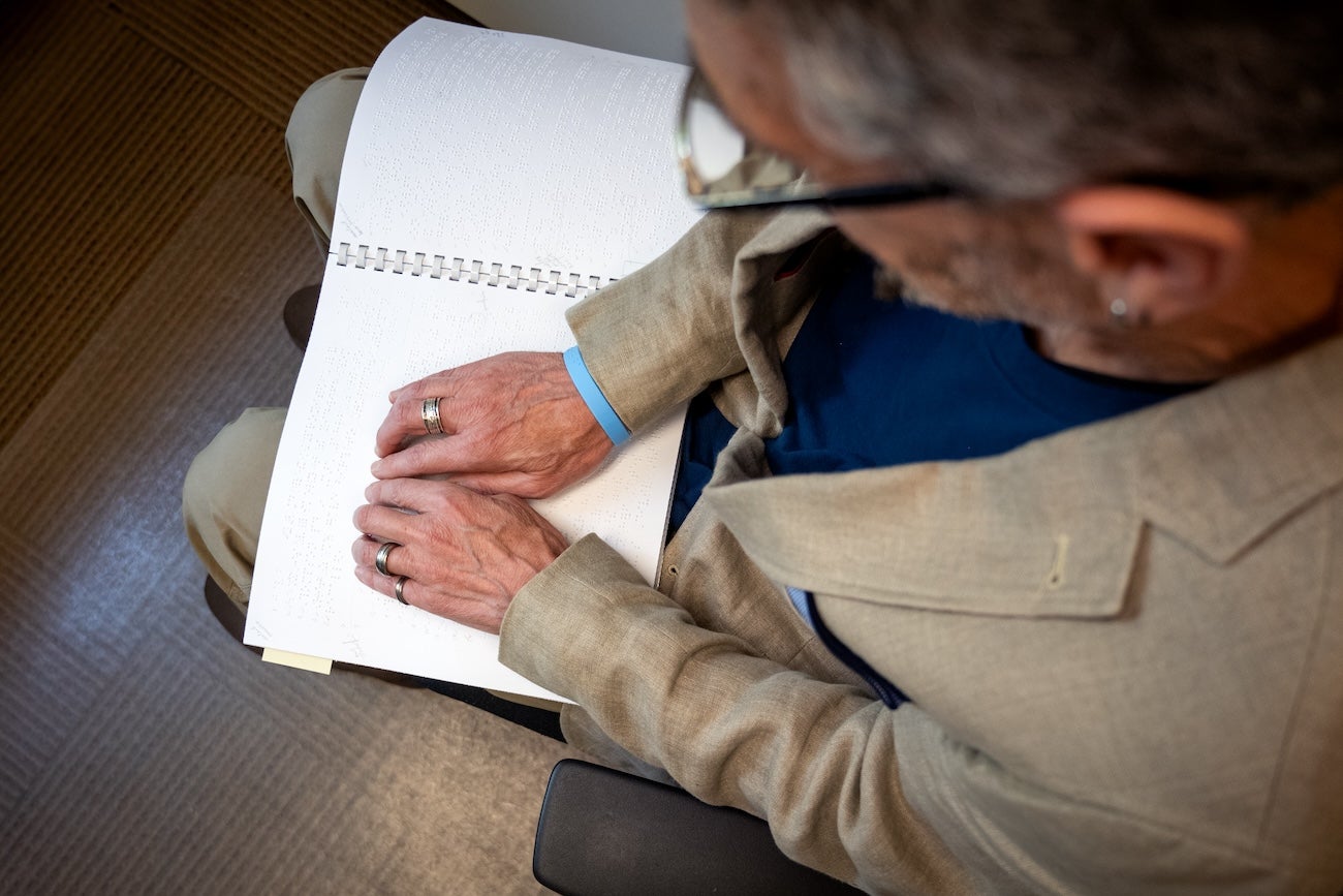 A person reads a braille text