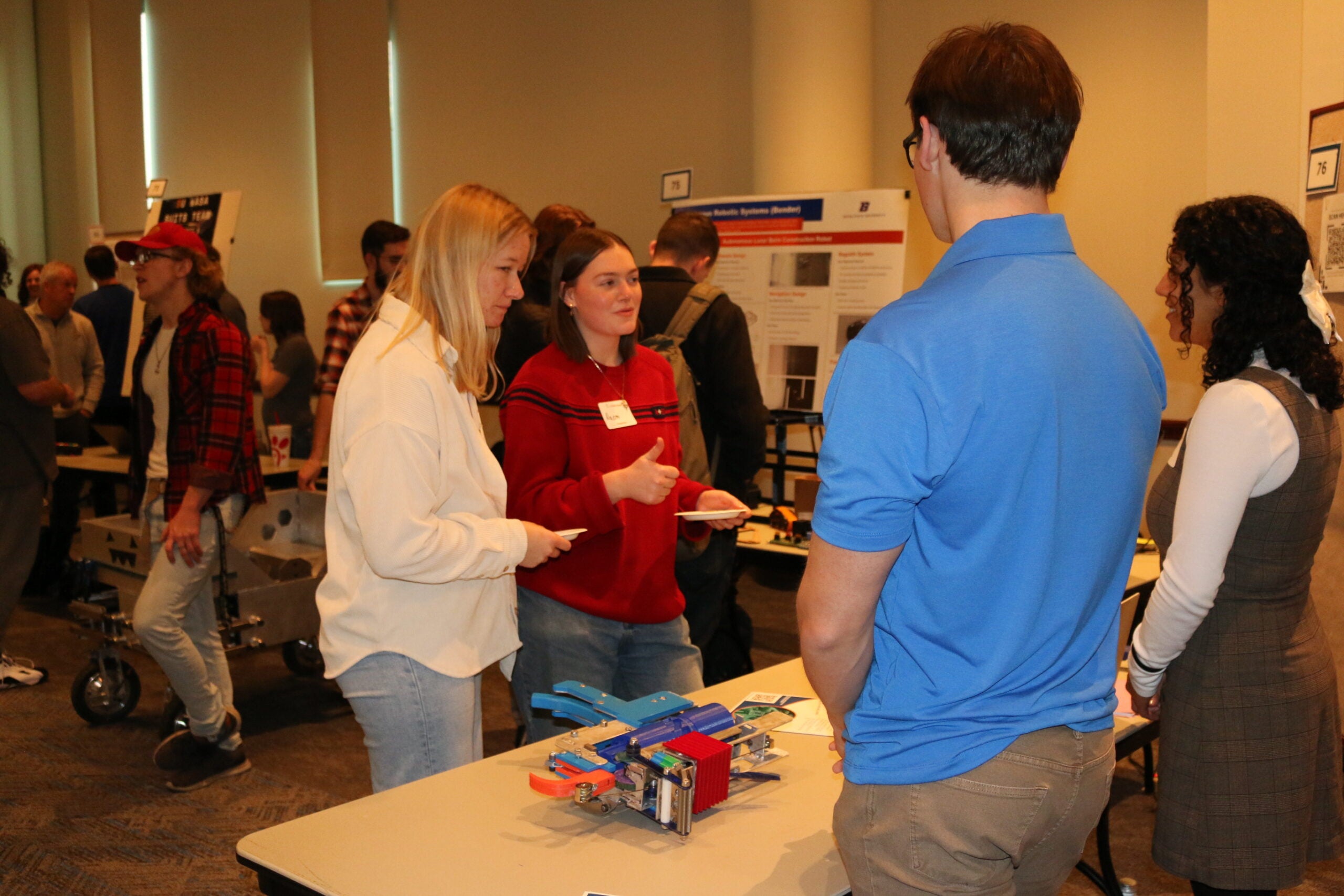 Students interacting with visitors at the 2024 SL/VIP Fall Expo