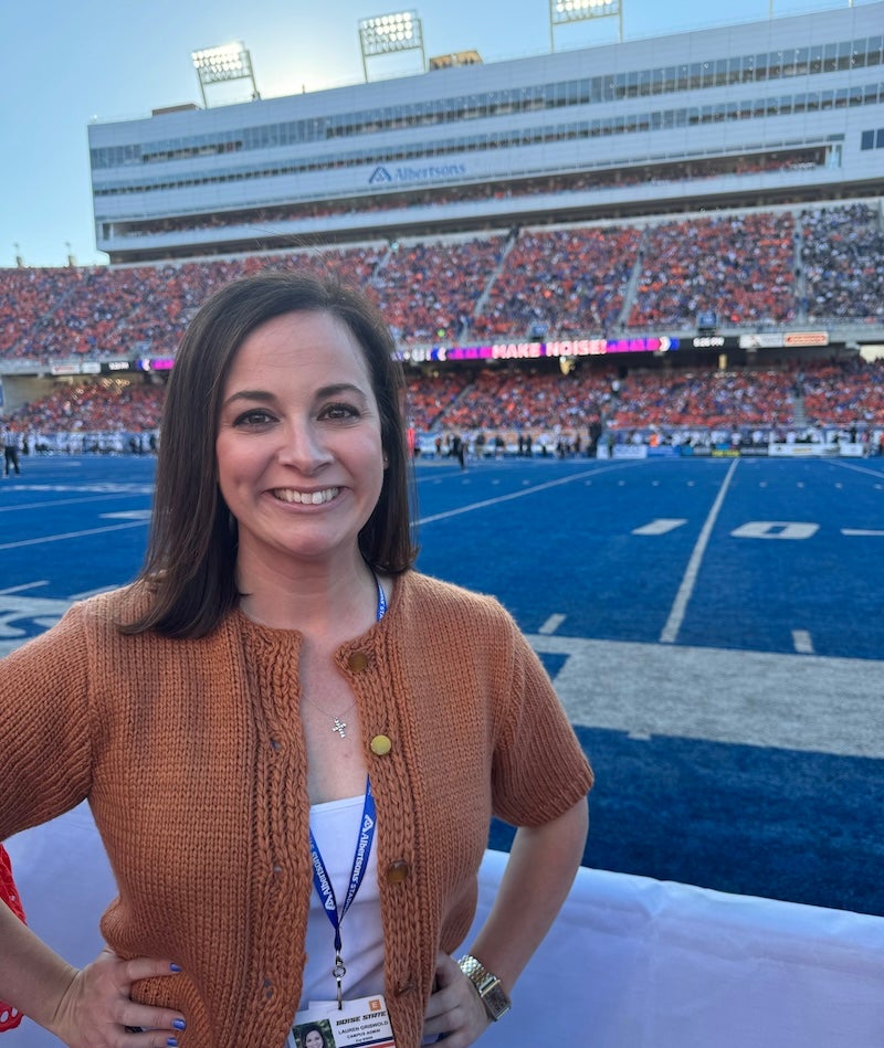 A person stands on a football field