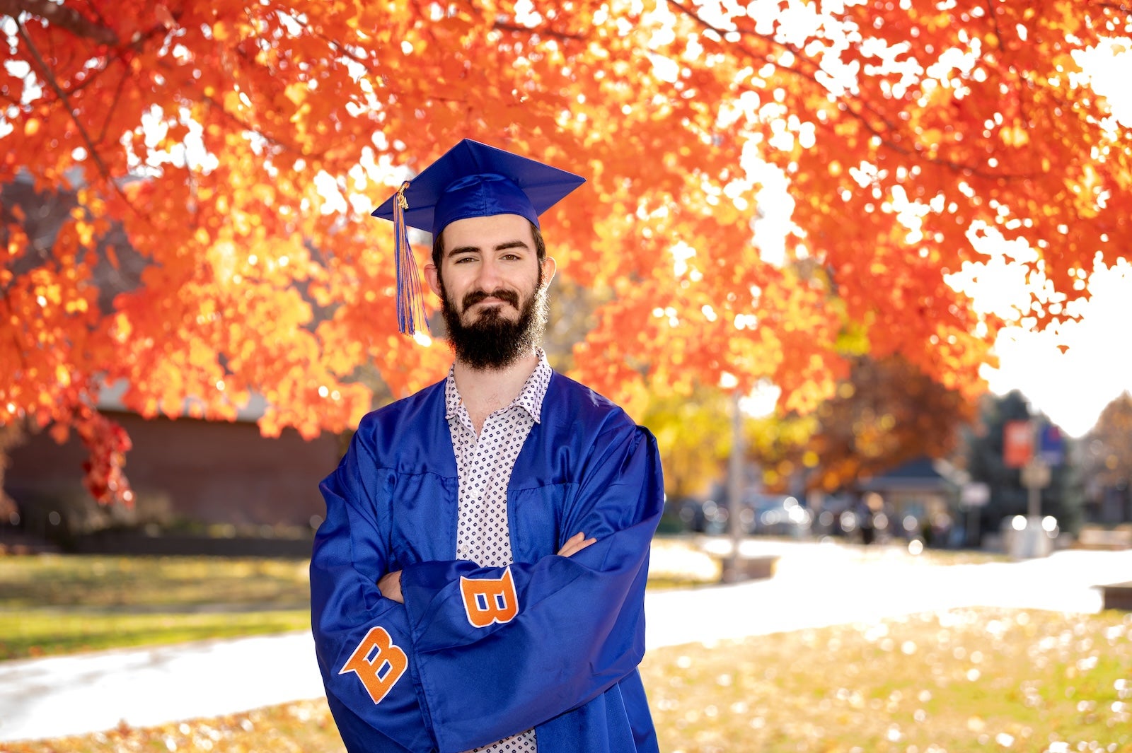 Oliver MacDonald wearing regalia on campus