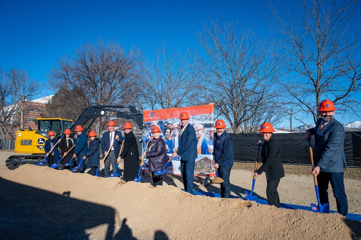 Persons in hard hats at a groundbreaking ceremony