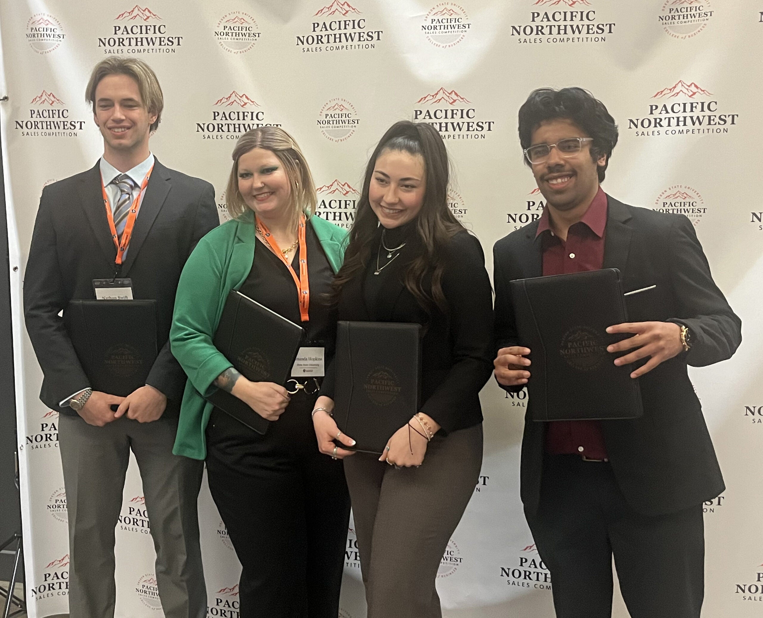 Four students pose with their awards