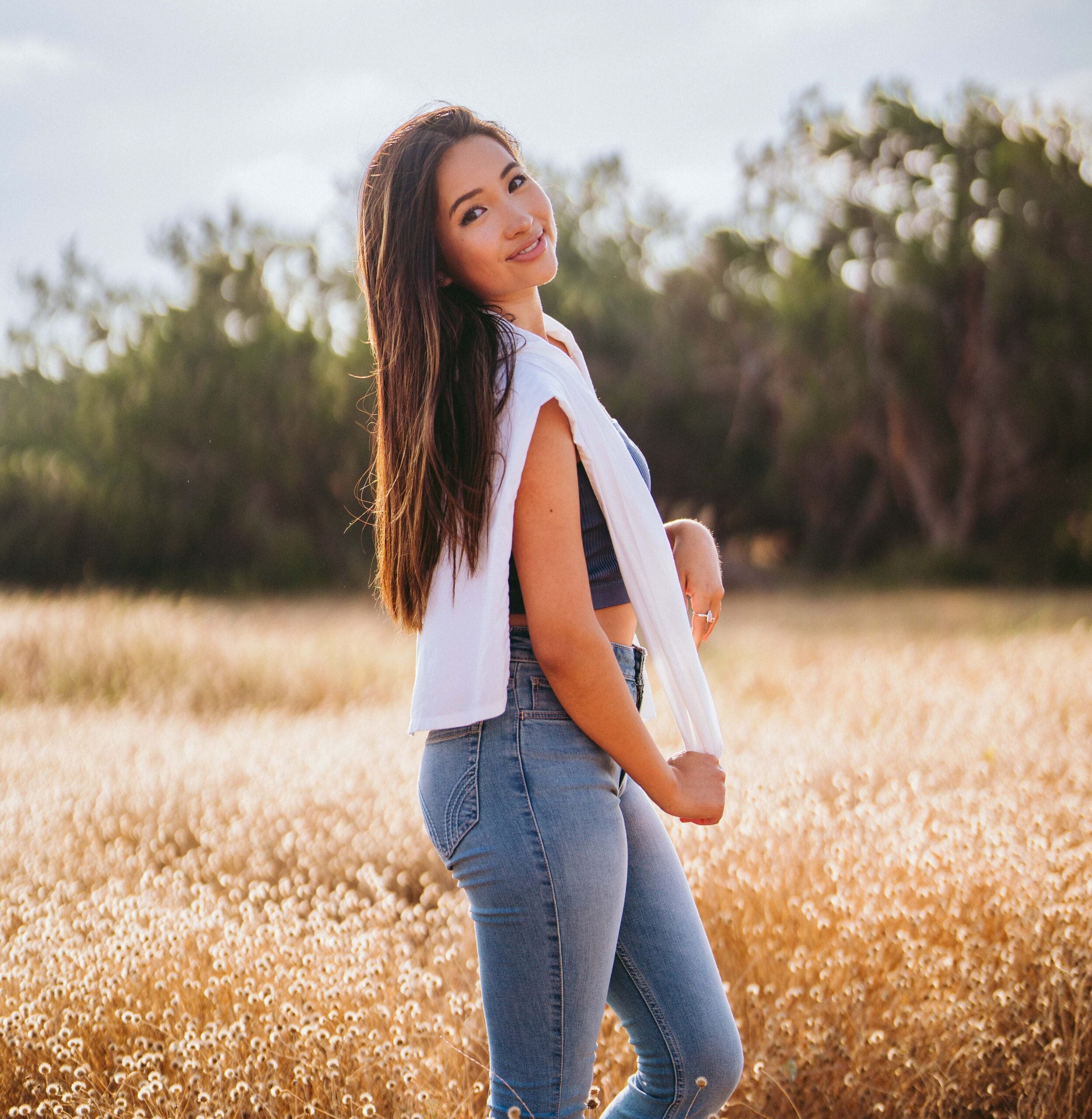 A person poses in a field